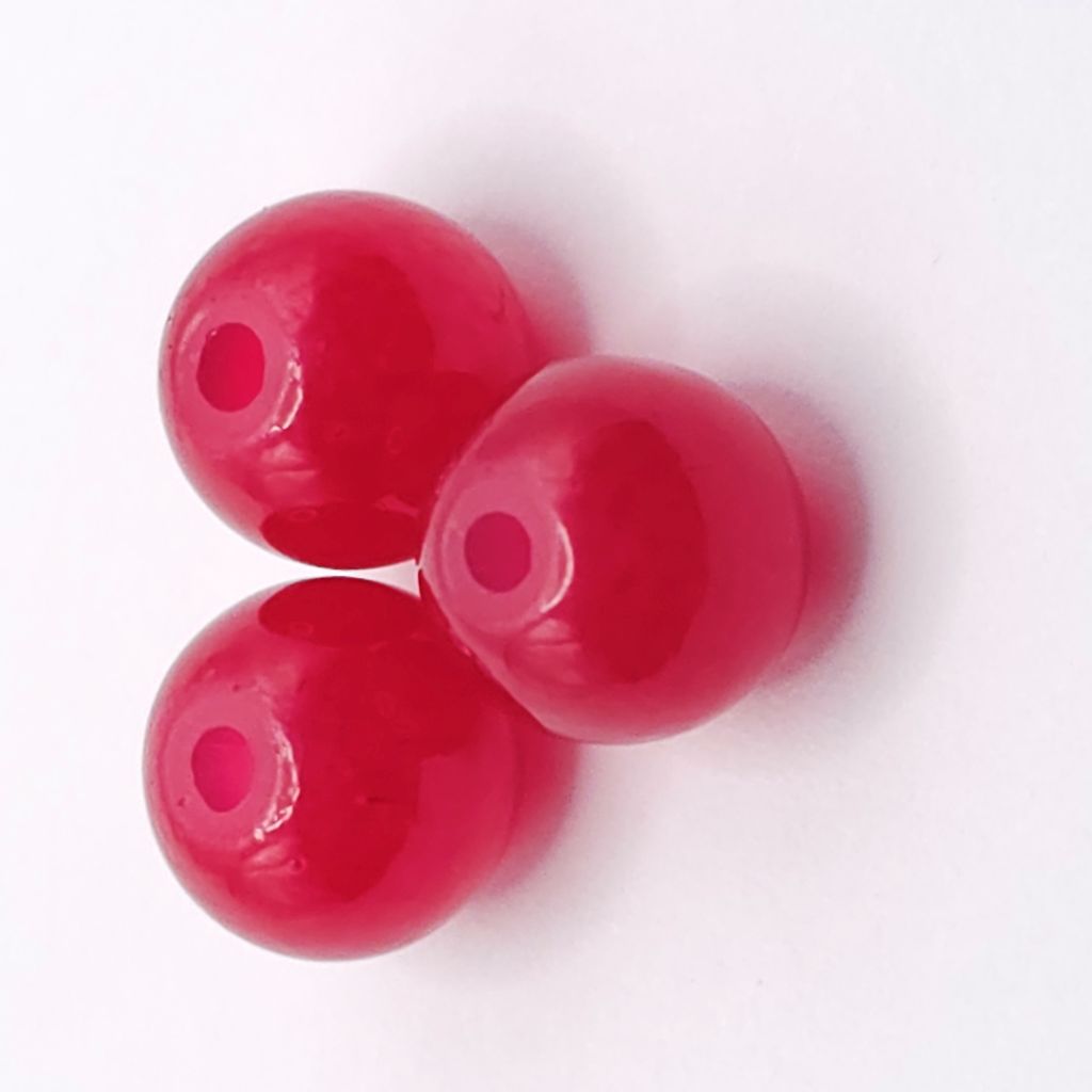 Three glossy red agate round beads with central holes, arranged in a triangle on a plain white background.