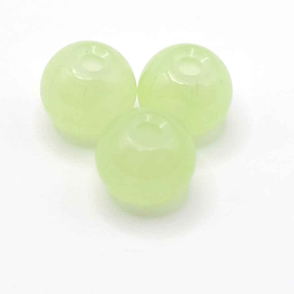 Three pale apple green translucent round beads with a central hole, arranged on a white background.