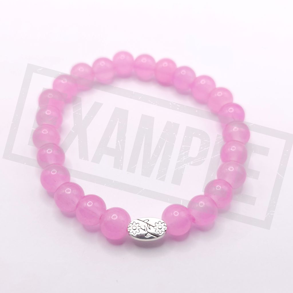 A fluorescent powder pink beaded bracelet with a small silver-toned oval charm featuring a floral or leaf-like pattern, photographed on a white background.