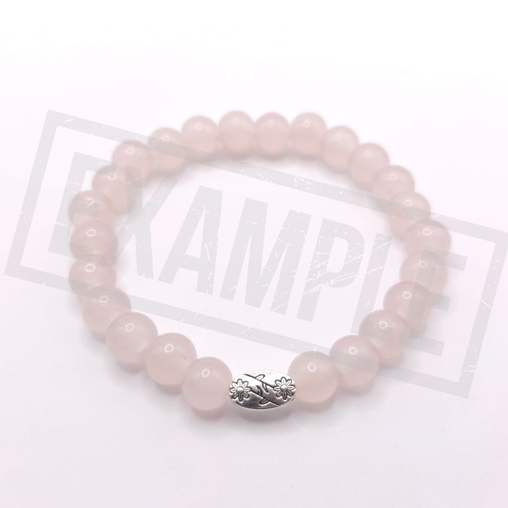 A fruit powder pink stone beaded bracelet with a silver-toned decorative clasp, displayed on a white background.