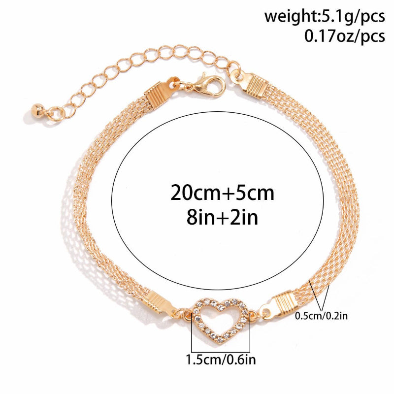 Gold anklet with heart charm and measurement details on a white background