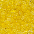 A close-up pile of small, round, translucent yellow beads with a glossy finish.