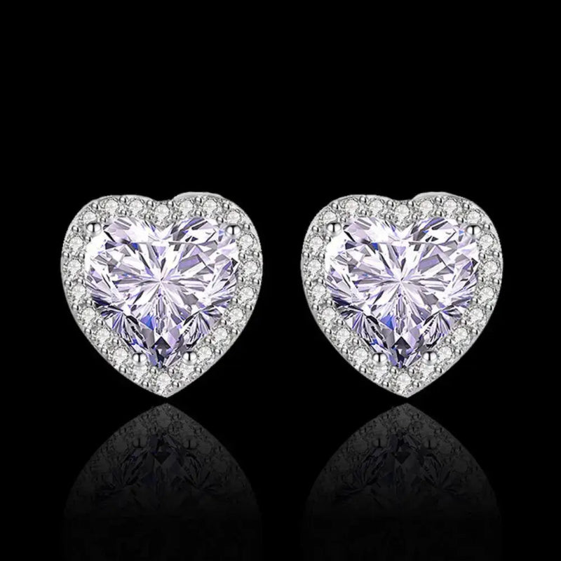 Heart-shaped diamond earrings on a black background