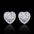 Heart-shaped diamond earrings on a black background