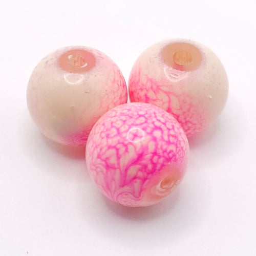 Three round glass beads with a pink and white marbled pattern, displayed on a clean white background.