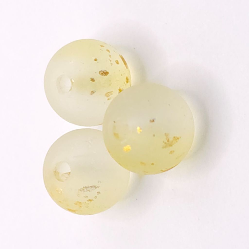 Three round translucent lemon yellow beads with small gold leaf inclusions, arranged on a white background.