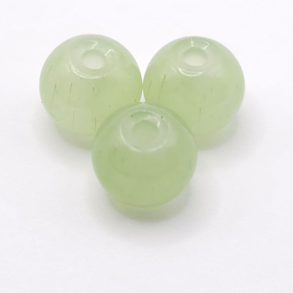 Three light aventurine green translucent round beads with drilled centers, arranged on a plain white background.