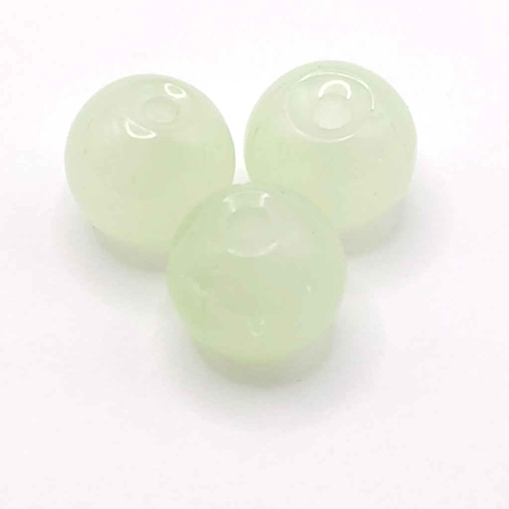 Three light green translucent round beads with pre-drilled holes, arranged on a white background.
