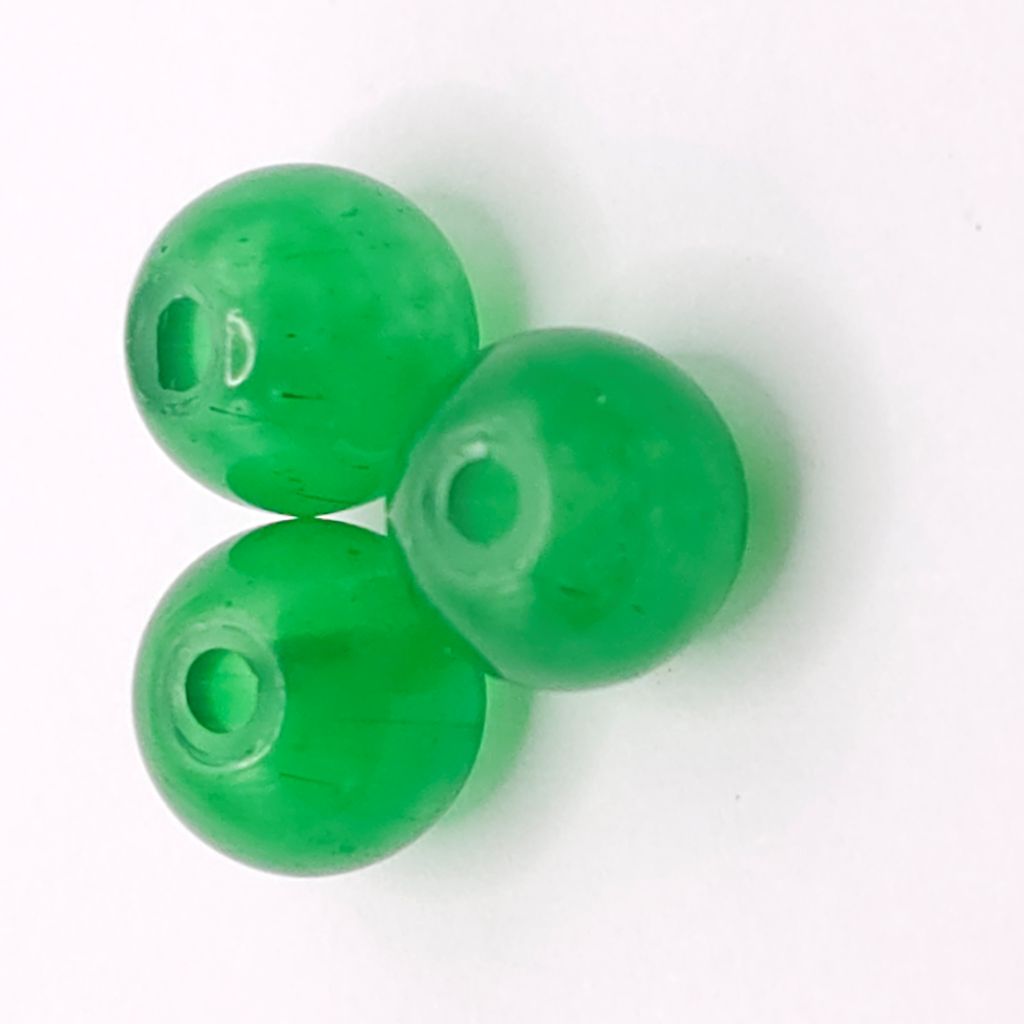 Three translucent light green round beads with center holes, arranged on a plain white background.