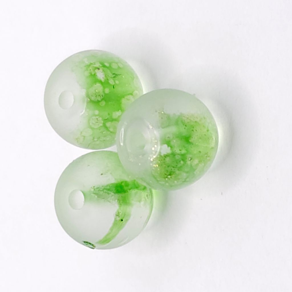 Three round translucent glass beads with a light lime green and white marbled pattern and gold foil flecks, displayed on a white background.