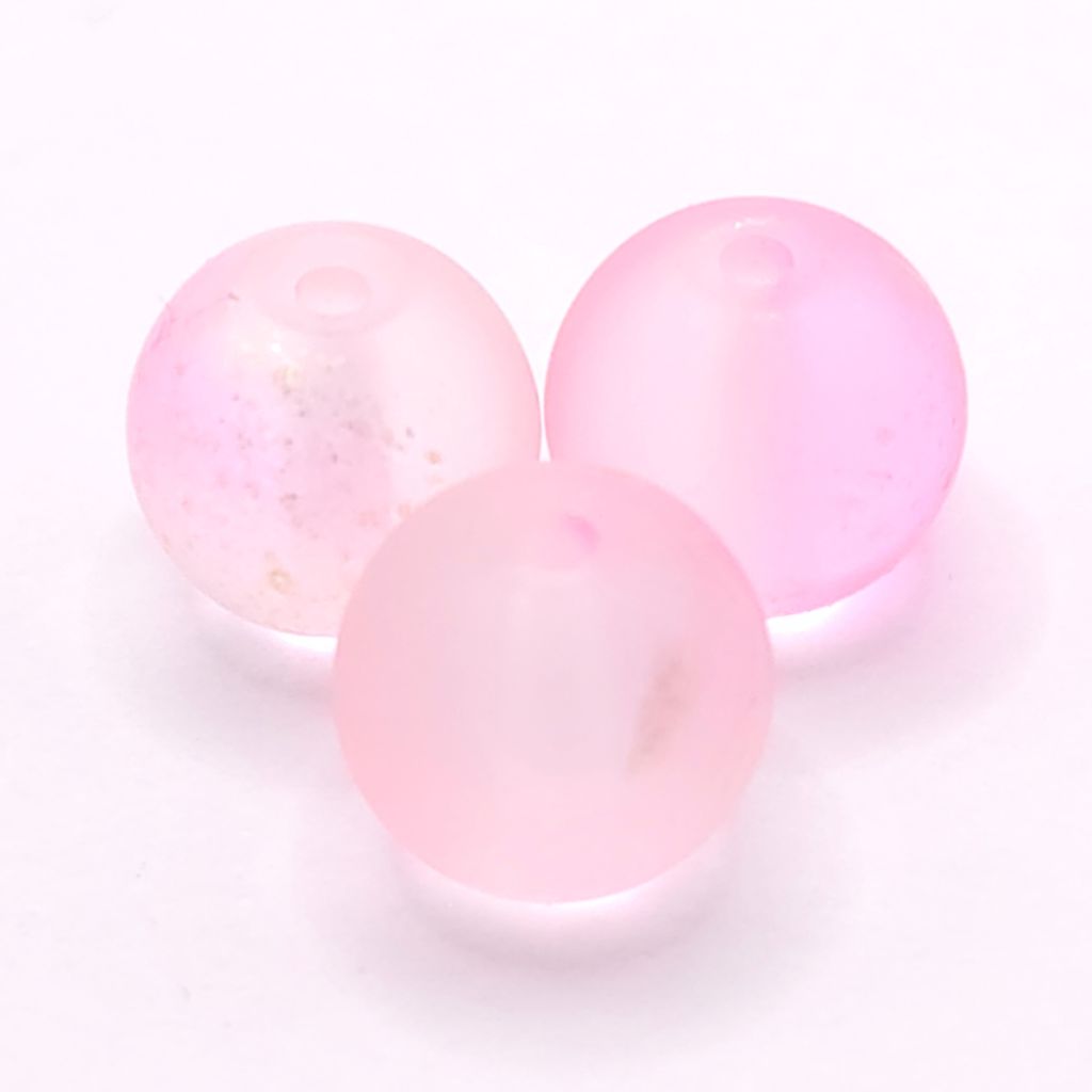 Three round, translucent light pink beads with small gold flecks, arranged on a white background.