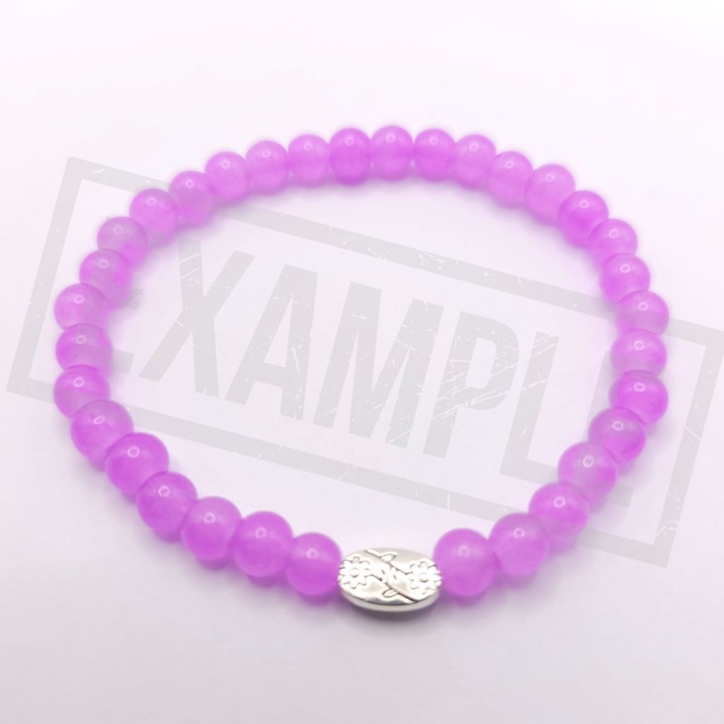 A purple beaded bracelet with a silver oval charm, displayed on a light gray background.