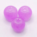 Three translucent lavender purple glass beads with a central hole, arranged in a triangle on a plain white background.