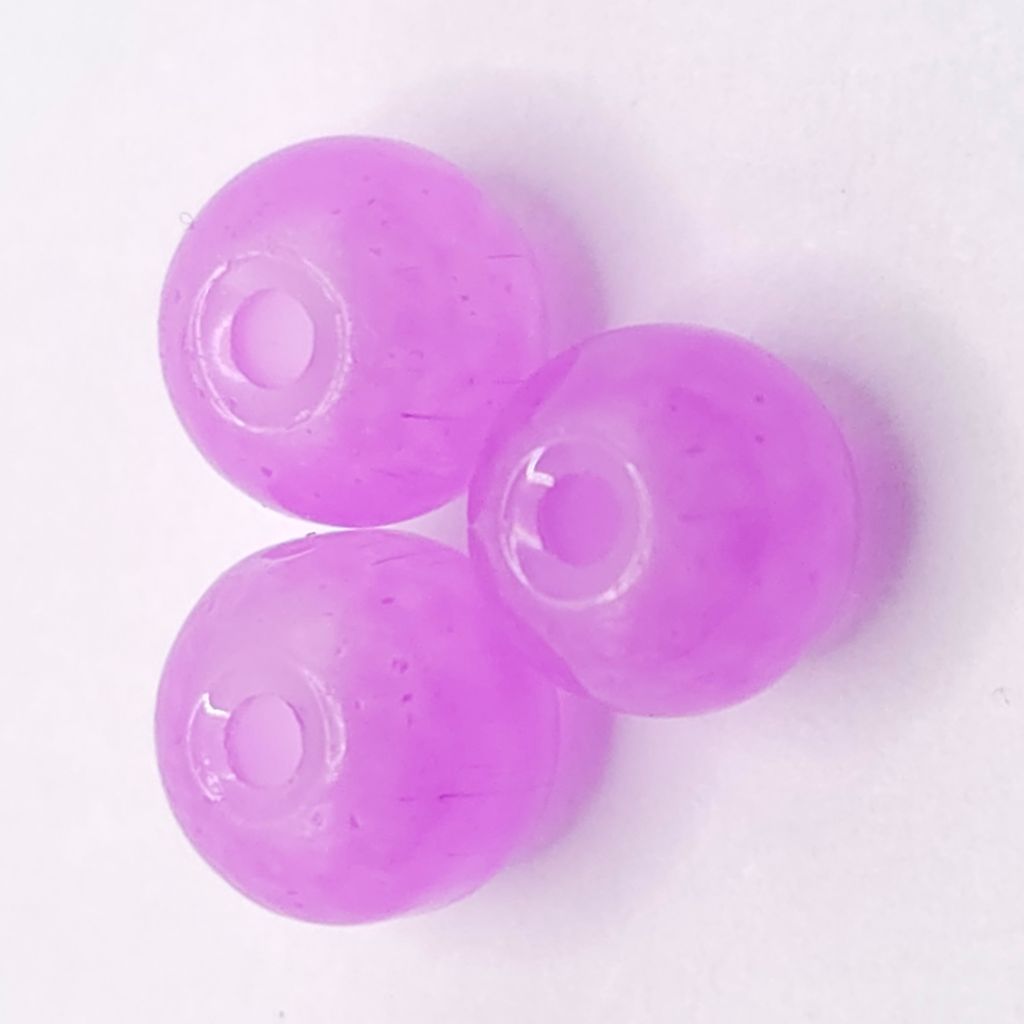 Three translucent lavender purple glass beads with a central hole, arranged in a triangle on a plain white background.
