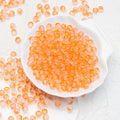 Orange frosted glass beads with a matte finish. Bright, warm and perfect for vibrant handmade jewellery.