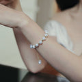 Pearl bracelet on a wrist with a blurred background