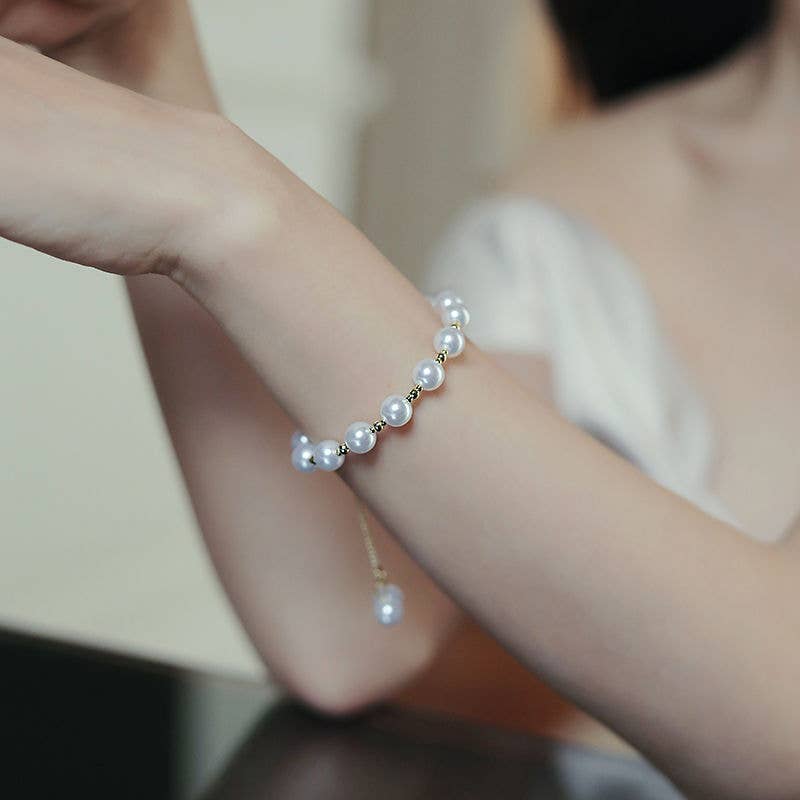 Pearl bracelet on a wrist with a blurred background