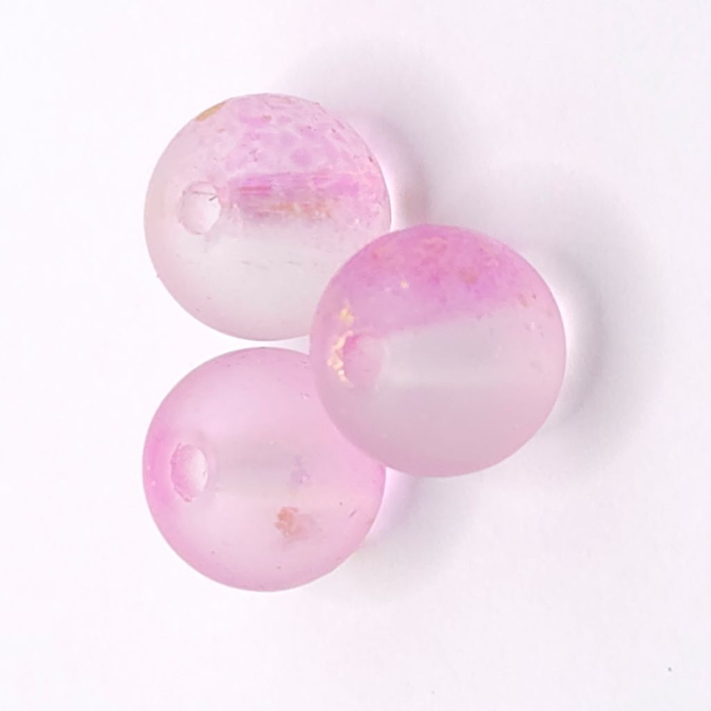Three round translucent pink glass beads with small gold flecks, arranged on a plain white background.