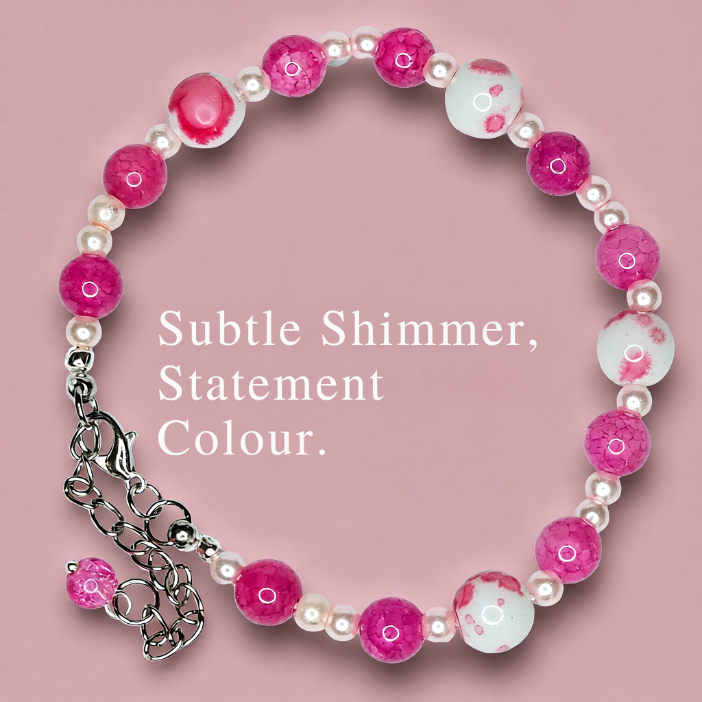 Bracelet with pink and white beads on a pink background