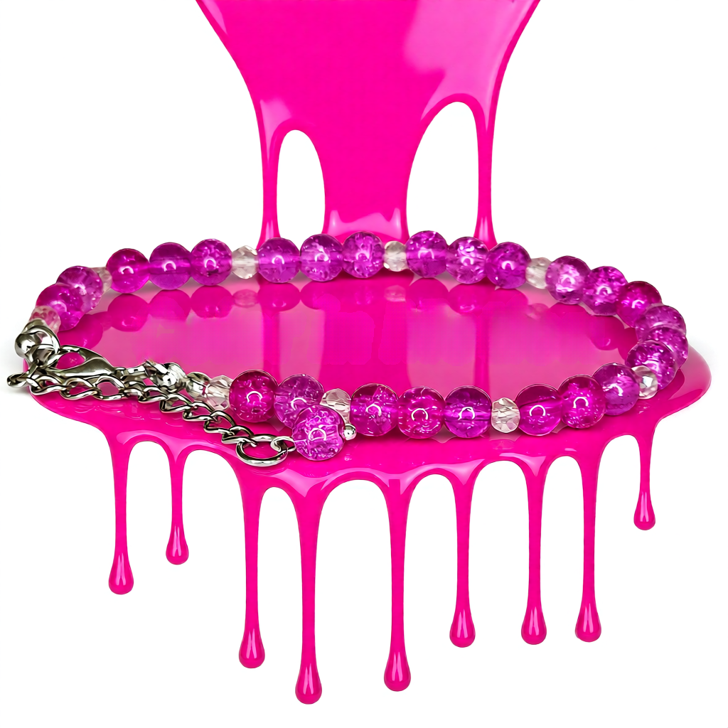 Pink chair with pink liquid and a beaded bracelet on a white background