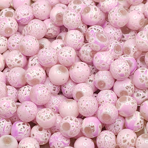 A close-up pile of round glass beads in lPlum and white, featuring a bubbly, lace-like pattern on the surface.