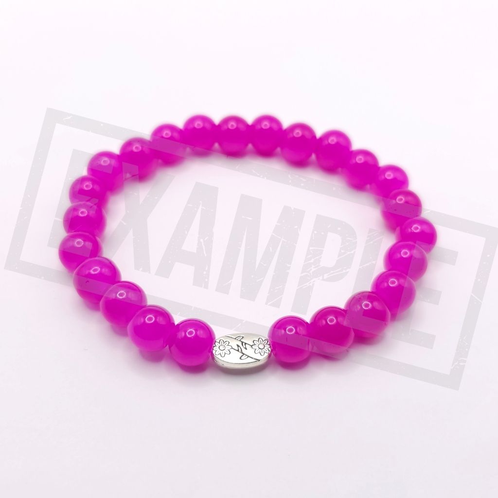 A beaded stretch bracelet made of purplish red round beads, featuring a small silver oval charm with a floral design, displayed on a white background.