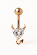 Rose gold belly button ring with heart-shaped gemstone on a white background
