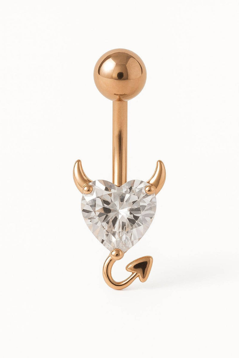 Rose gold belly button ring with heart-shaped gemstone on a white background