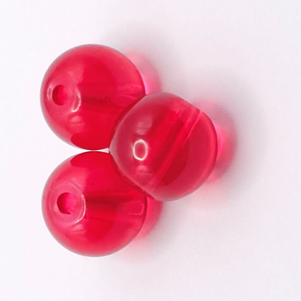 Three translucent red glass beads with a central hole, arranged in a triangle on a plain white background.