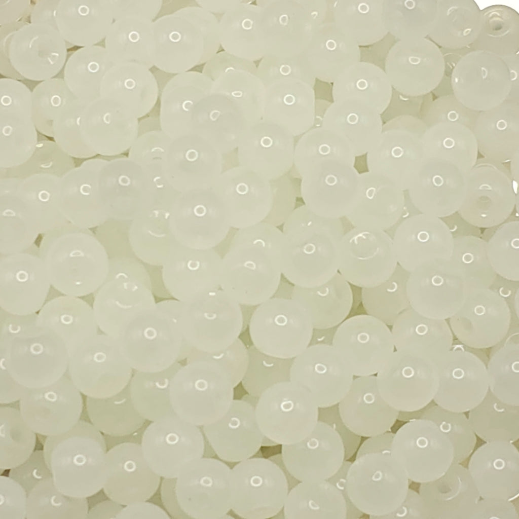 A close-up pile of small, round, translucent white beads with a smooth, glossy finish.