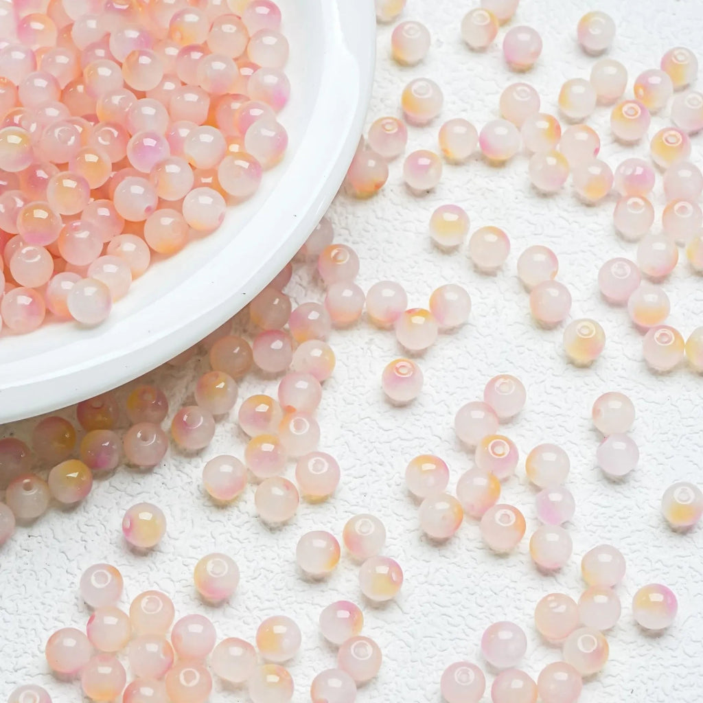Yellow‑Pink glossy gradient beads with a bright shine. Colourful and perfect for playful handmade jewellery.
